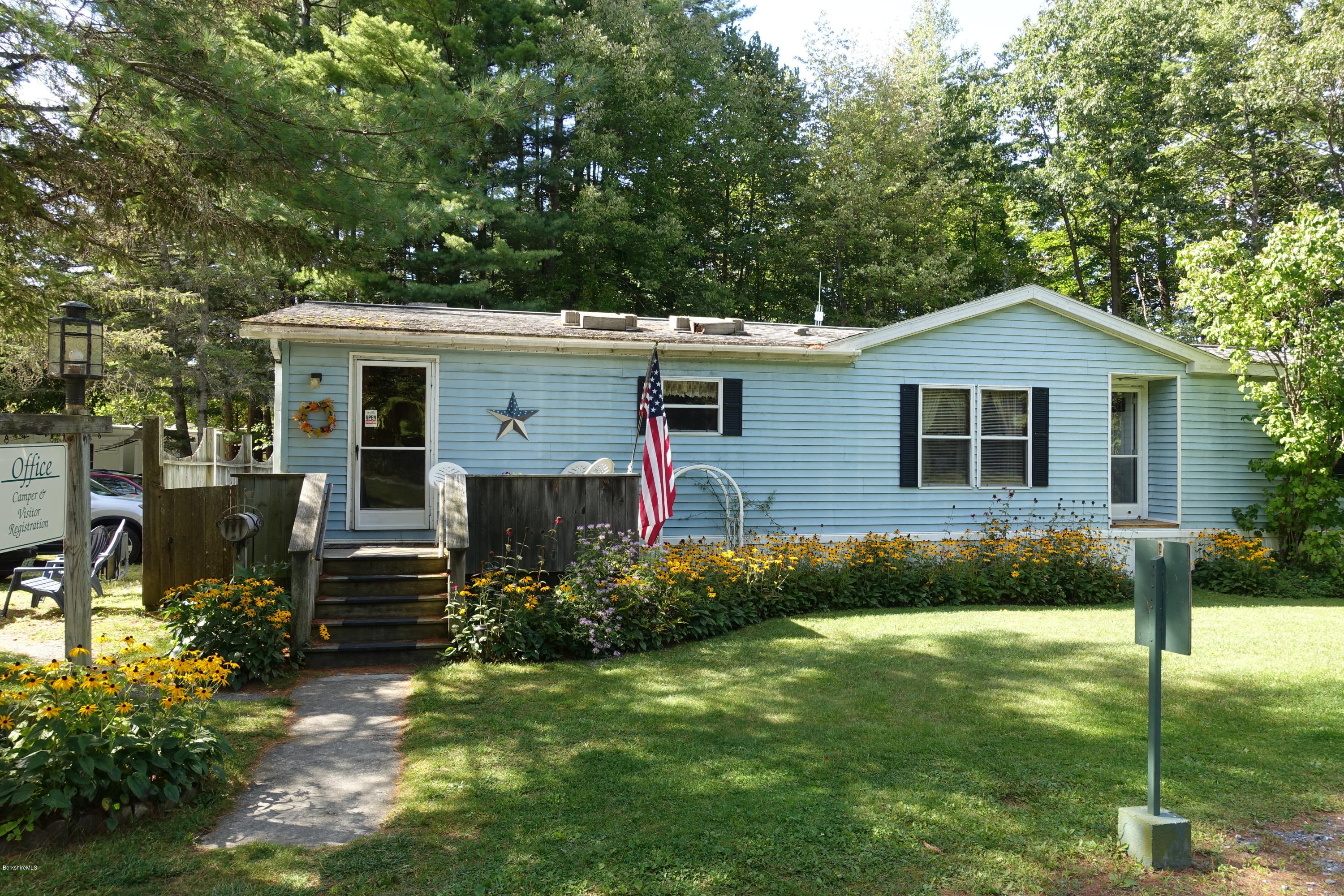 a front view of house with yard and green space