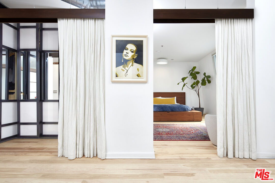615 Hampton Drive, Unit B201 Venice, CA 90291 - Photo 15 of 39 a view of a hallway to a livingroom with wooden floor and windows