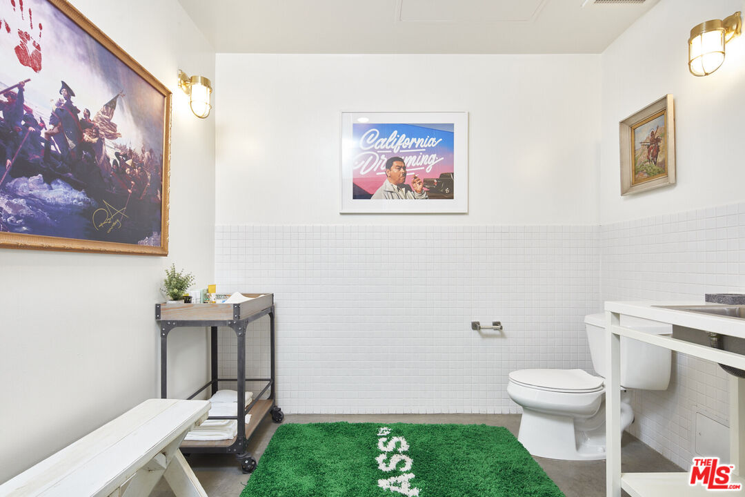 615 Hampton Drive, Unit B201 Venice, CA 90291 - Photo 29 of 39 a white toilet sitting next to a bathroom sink