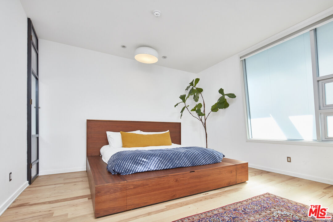 615 Hampton Drive, Unit B201 Venice, CA 90291 - Photo 9 of 39 a bedroom with a bed and window