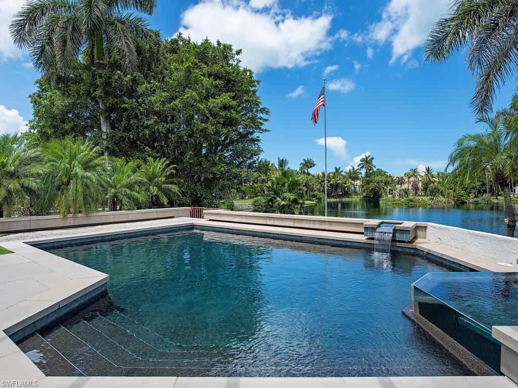 2680 Lantern Lane Naples, FL 34102 - Photo 1 of 24 a view of a swimming pool with a patio