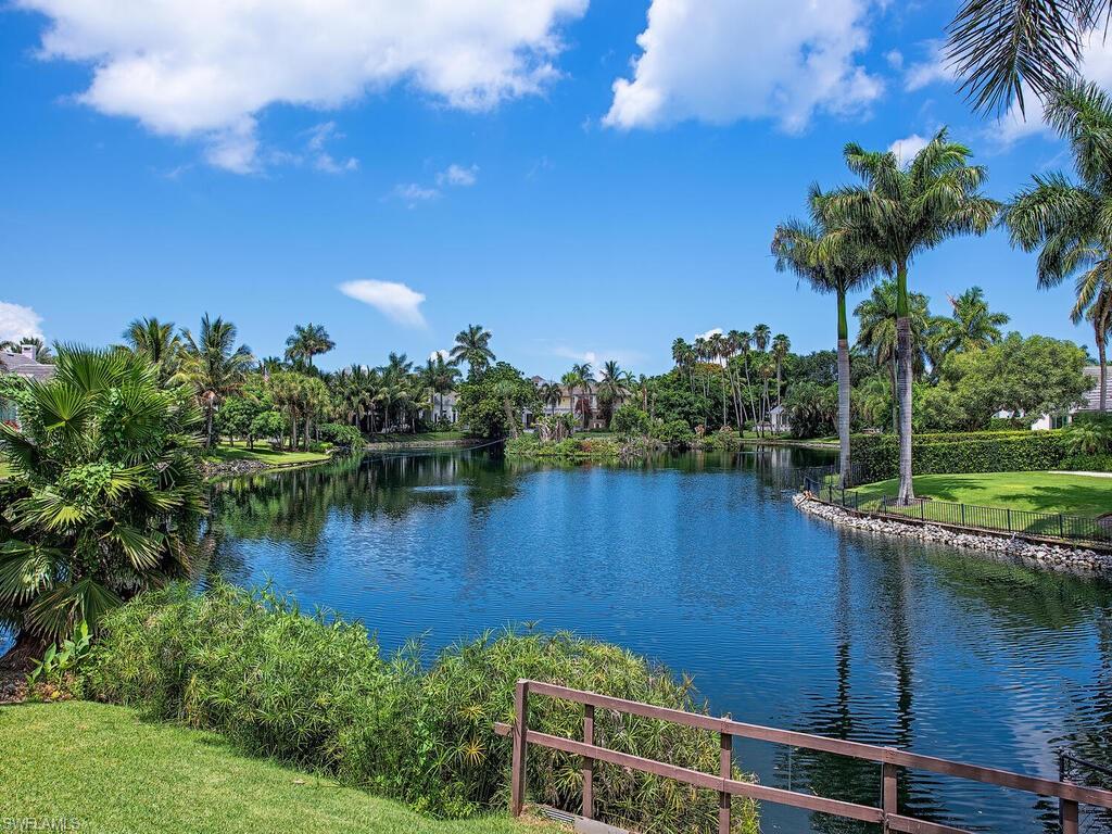 2680 Lantern Lane Naples, FL 34102 - Photo 1 of 22 a view of a lake with a house in the background