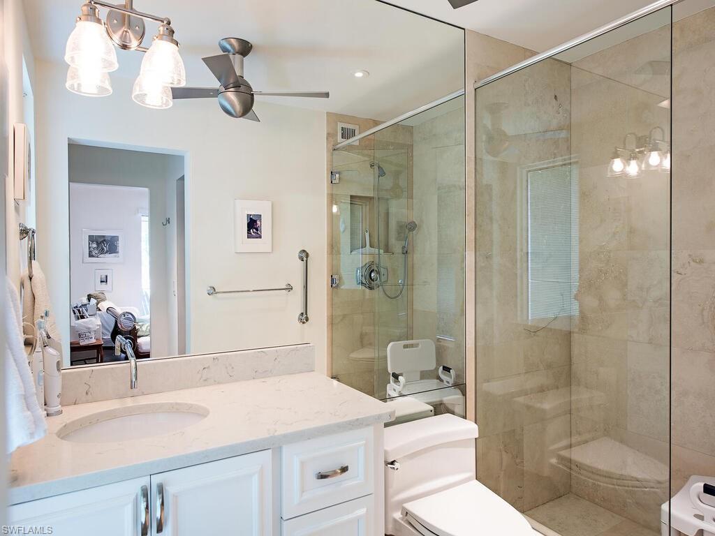 2680 Lantern Lane Naples, FL 34102 - Photo 13 of 24 a bathroom with a sink a toilet and shower