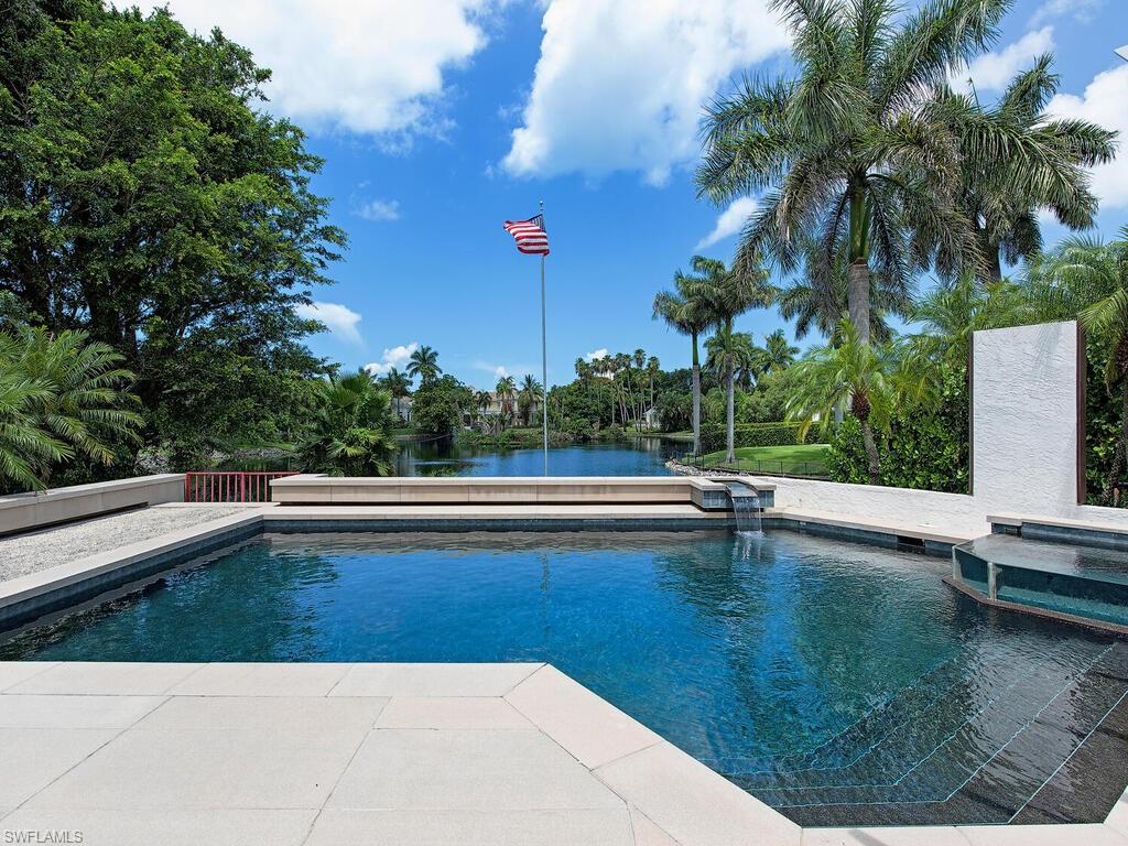 2680 Lantern Lane Naples, FL 34102 - Photo 18 of 24 a view of a swimming pool with a yard