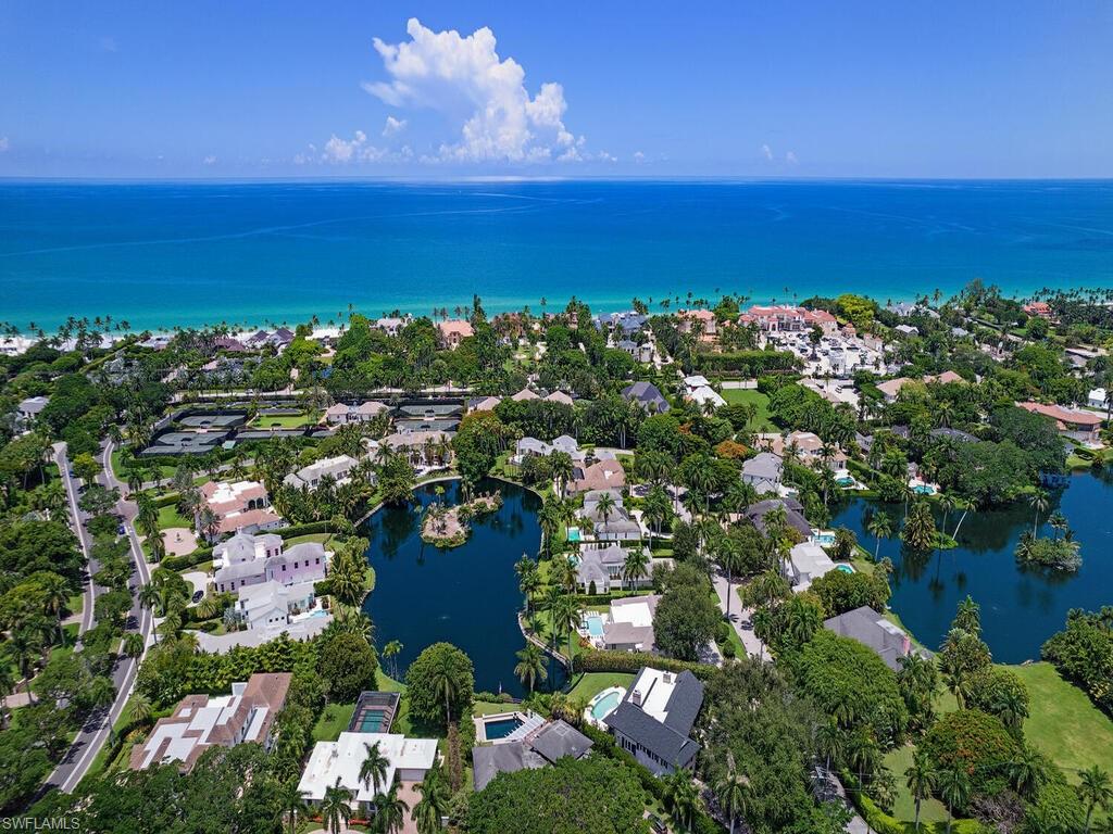 2680 Lantern Lane Naples, FL 34102 - Photo 22 of 24 an aerial view of a houses with a lake view