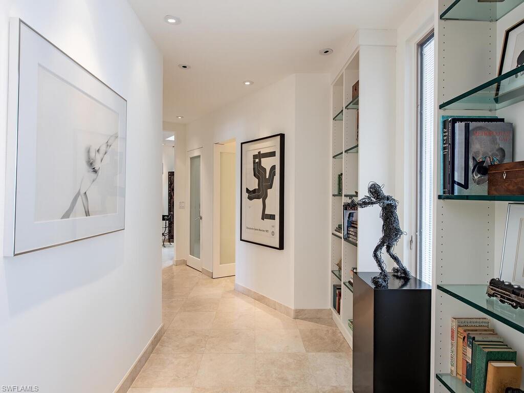 2680 Lantern Lane Naples, FL 34102 - Photo 9 of 24 a view of a hallway with paintings on the wall