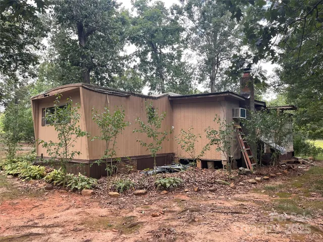 a backyard of a house with barbeque oven