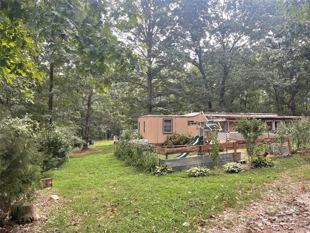 a view of a backyard with table and chairs