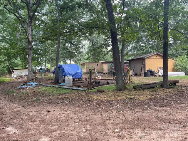 a backyard of a house with barbeque oven table and chairs