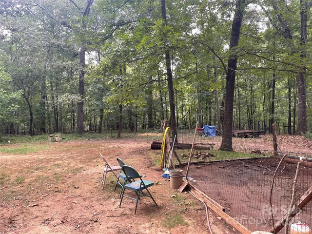 a view of a backyard with sitting area