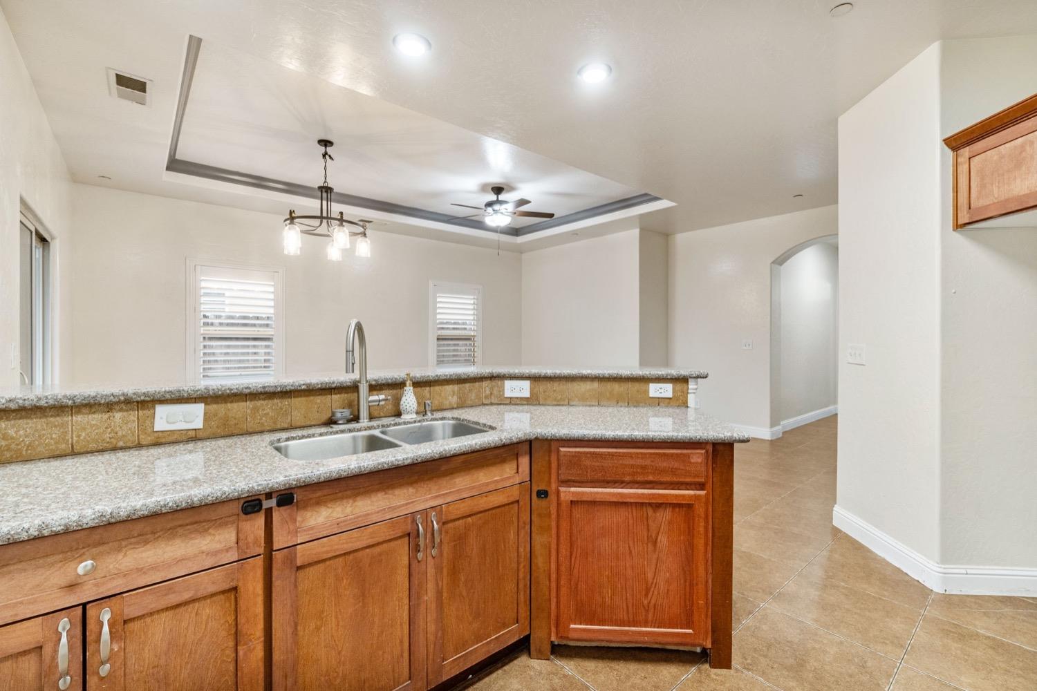 1156 Berry Drive Madera, CA 93637 - Photo 11 of 29 a kitchen with a sink and a refrigerator