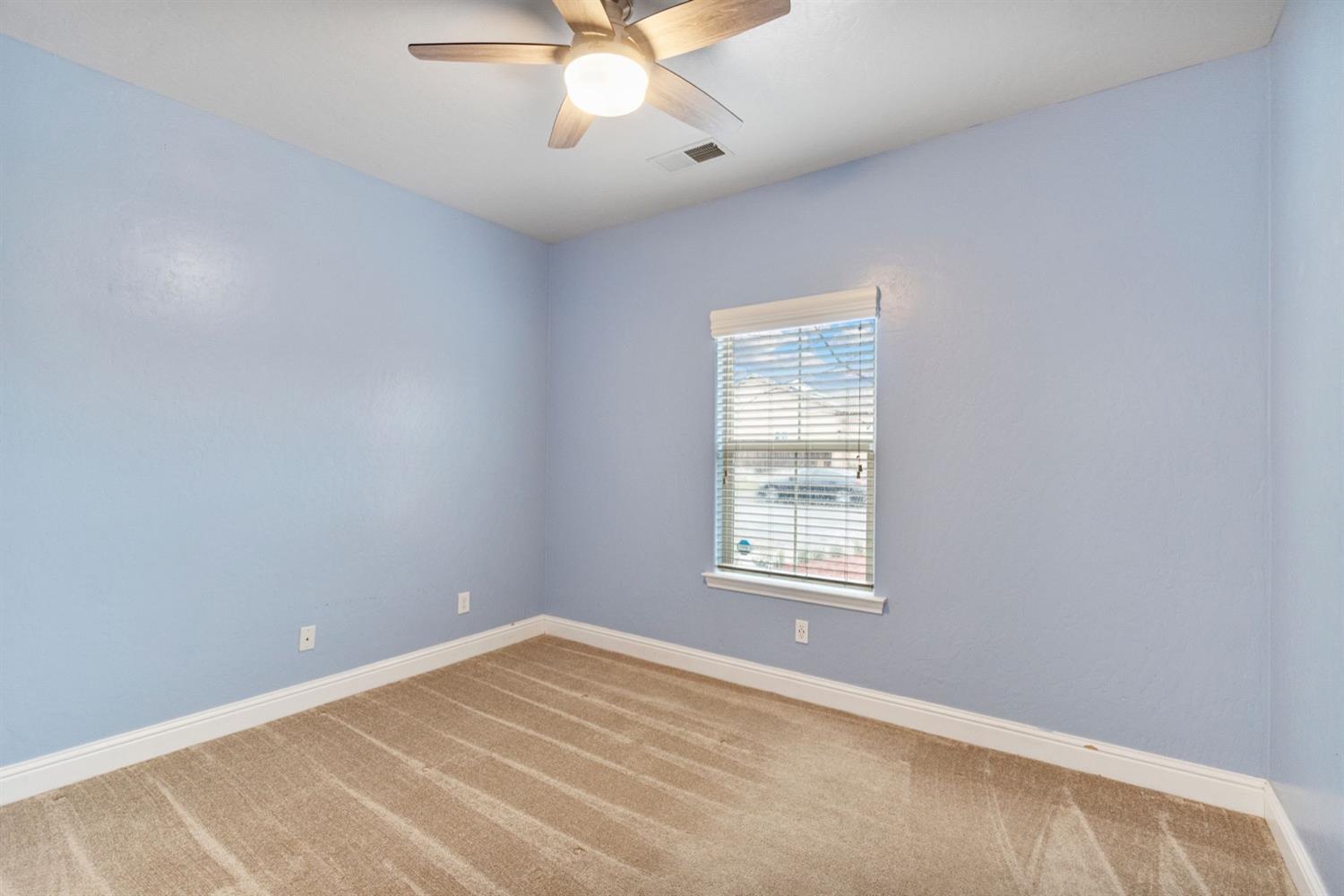 1156 Berry Drive Madera, CA 93637 - Photo 13 of 29 an empty room with a window and ceiling fan