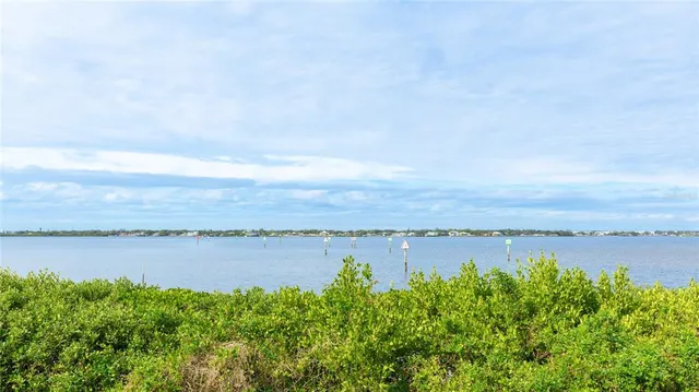a view of a lake with houses in the back
