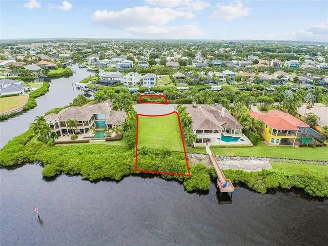 an aerial view of a house with a garden and lake view