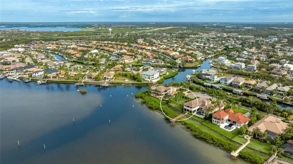 an aerial view of residential houses with outdoor space and river