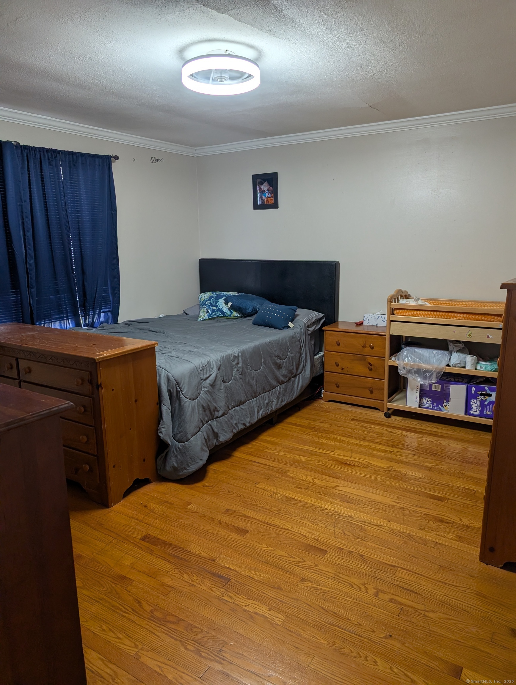2805 Boston Post Road Guilford, CT 06437 - Photo 11 of 35 a bedroom with a bed and a book shelf
