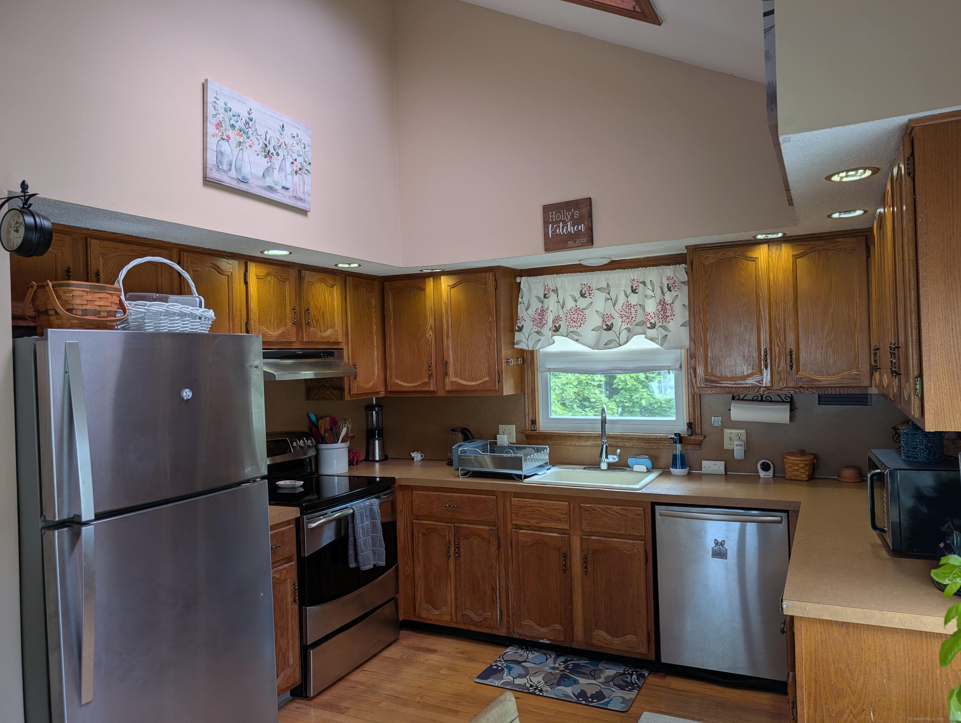 2805 Boston Post Road Guilford, CT 06437 - Photo 18 of 35 a kitchen with stainless steel appliances a refrigerator a sink a stove and a refrigerator