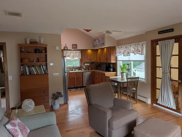 a living room with furniture a rug and a large window