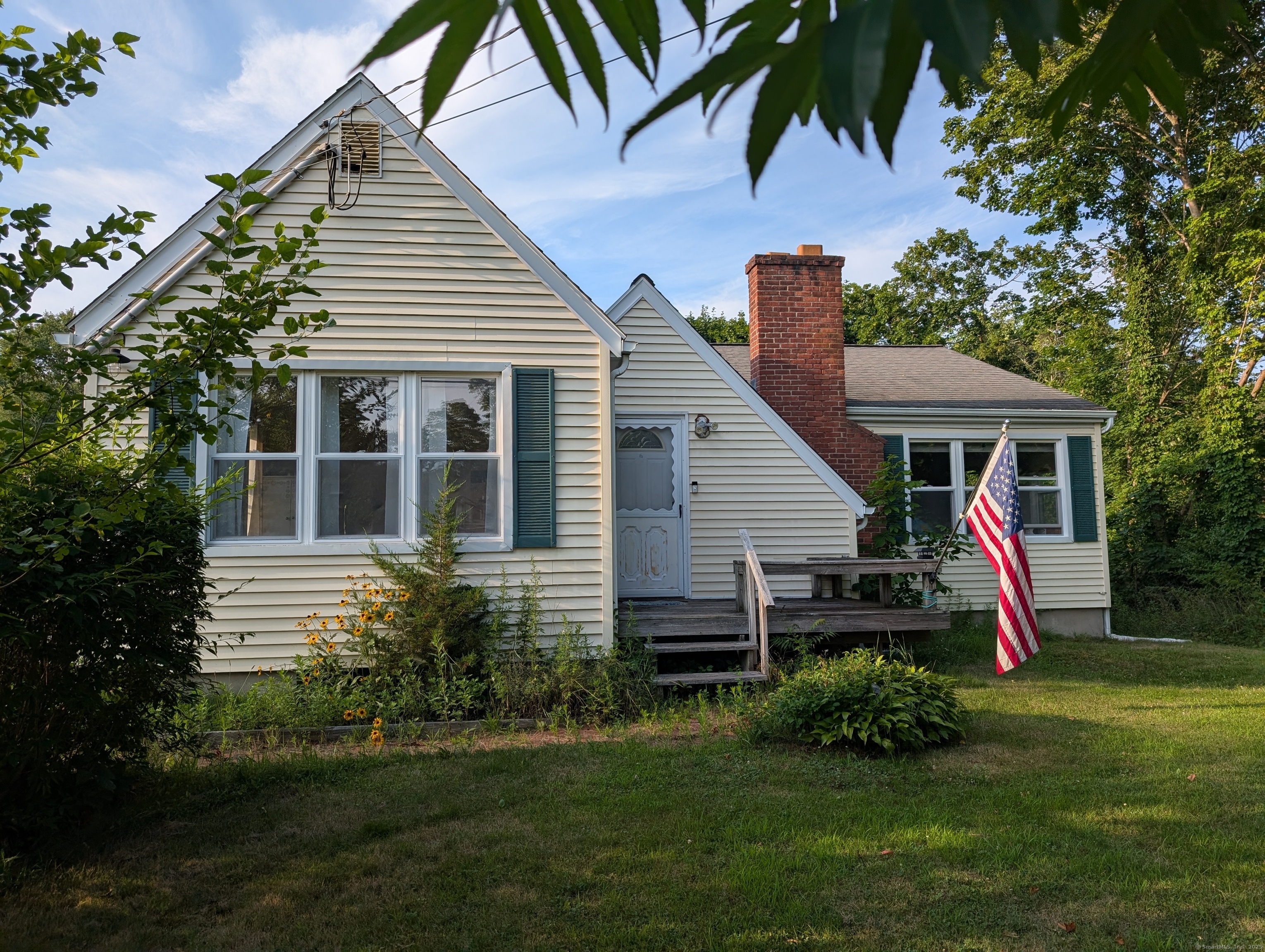 2805 Boston Post Road Guilford, CT 06437 - Photo 33 of 35 a view of backyard with table and chairs and potted plants