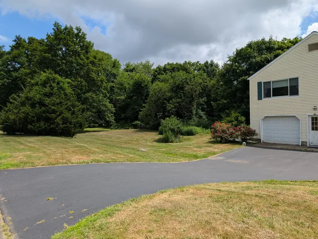 a view of a yard with basketball court
