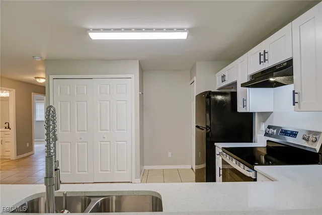 a kitchen with stainless steel appliances a refrigerator and a stove
