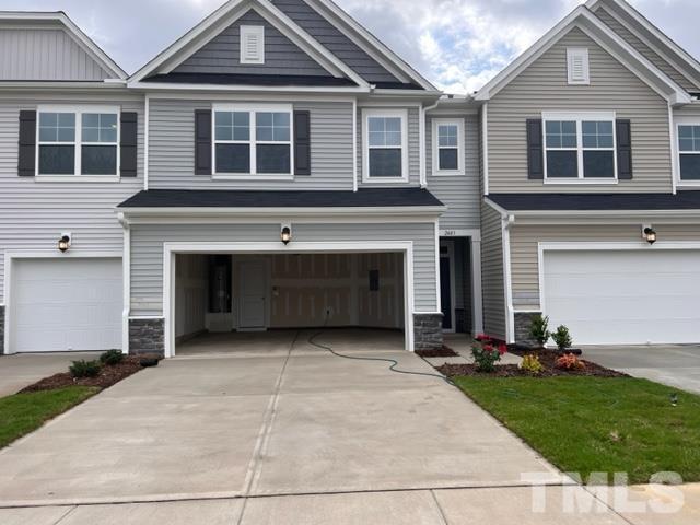2403 Chert Lane, Unit 2403 Raleigh, NC 27610 - Photo 1 of 19 a front view of a house with a yard and garage