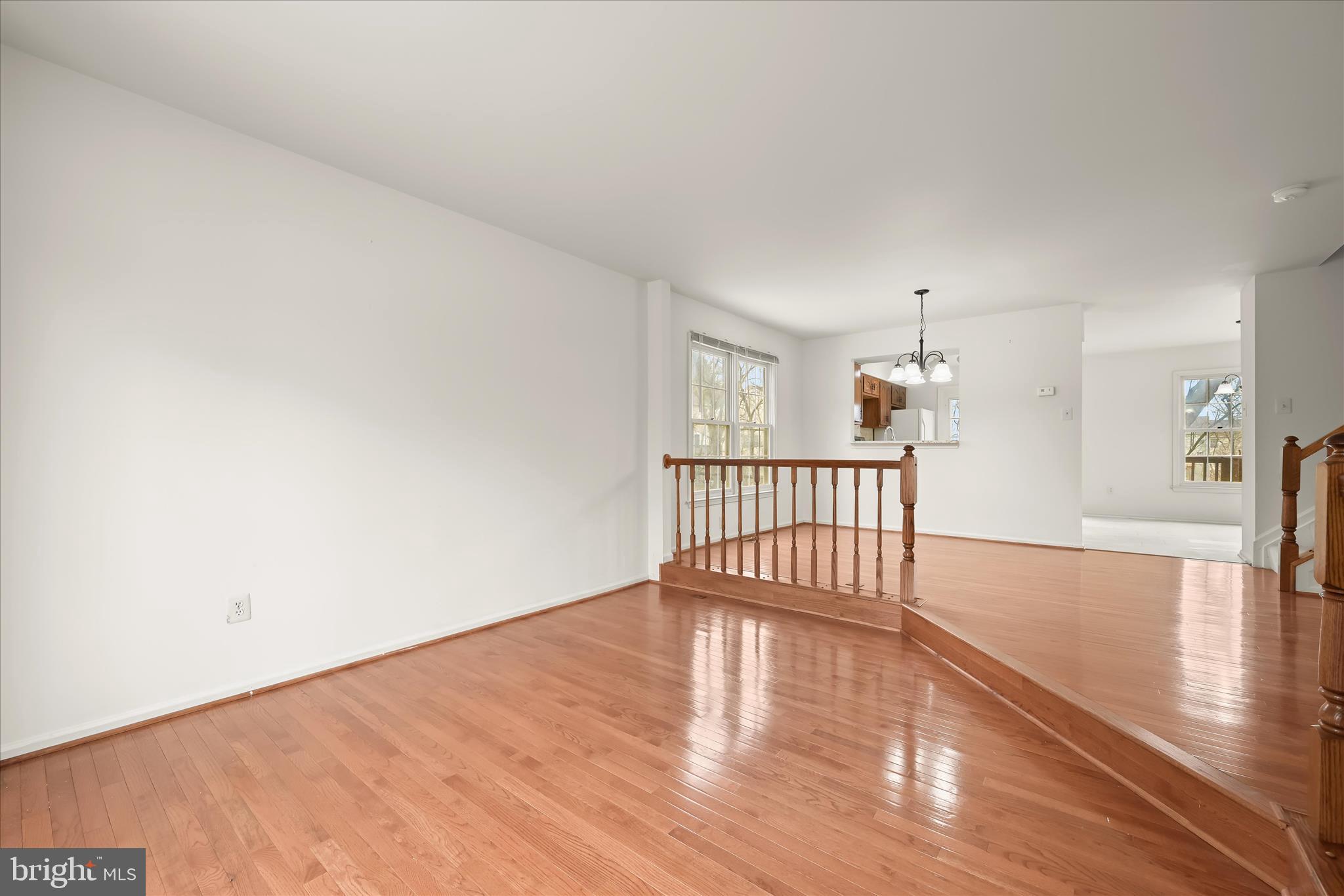 4750 Rams Horn Row Ellicott City, MD 21042 - Photo 12 of 54 a view of an empty room with wooden floor and a window