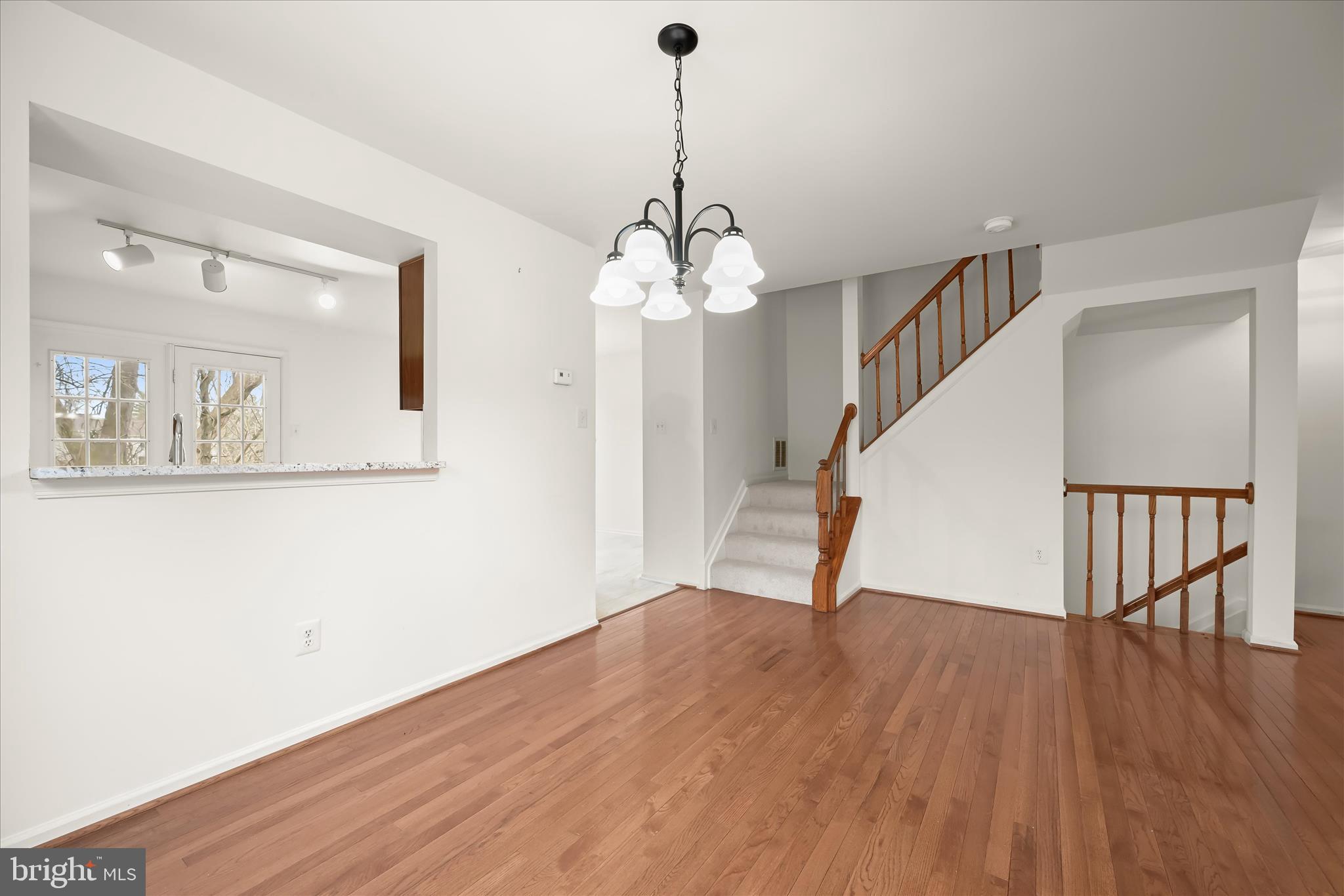 4750 Rams Horn Row Ellicott City, MD 21042 - Photo 17 of 54 a view of a room with wooden floor and stairs