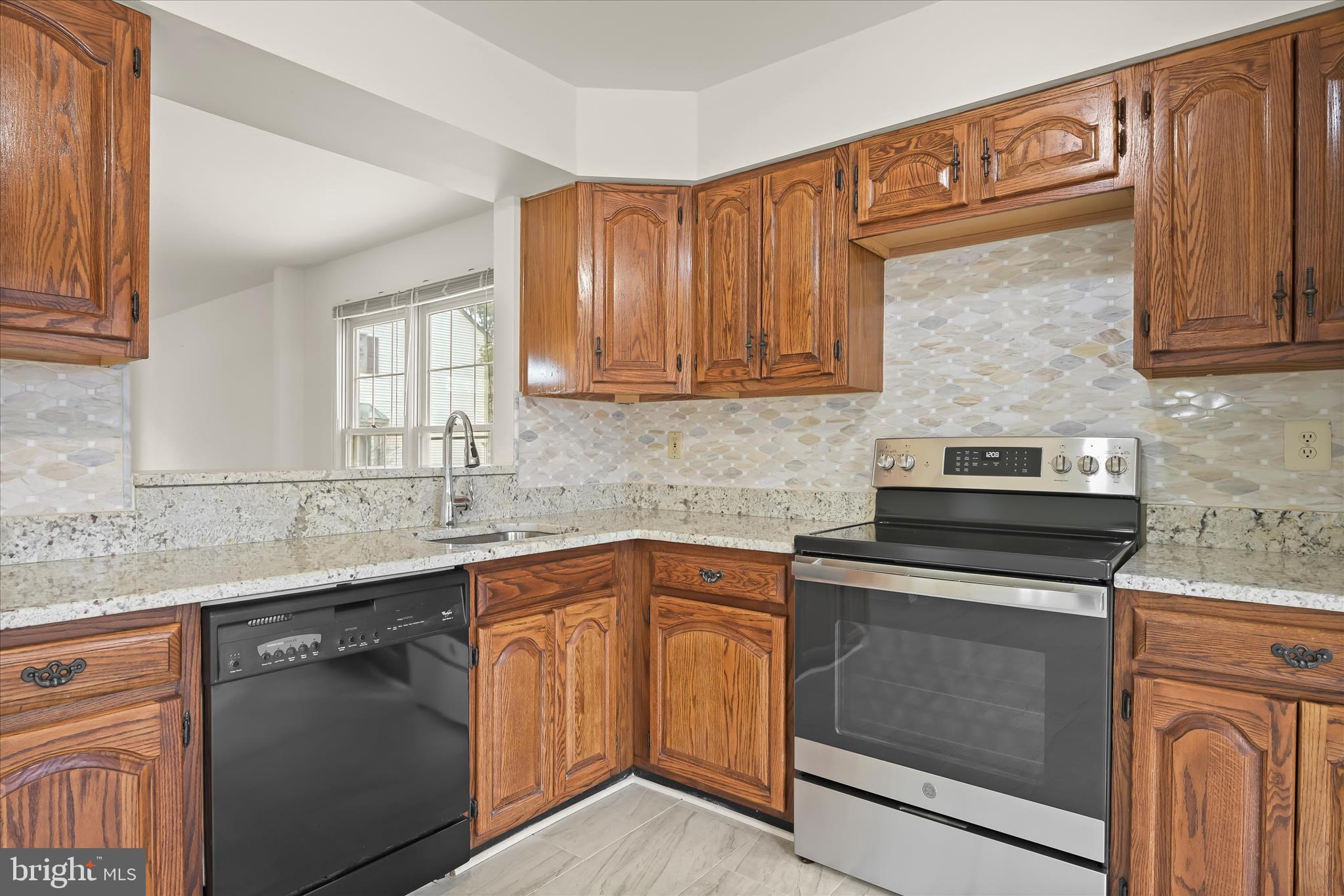 4750 Rams Horn Row Ellicott City, MD 21042 - Photo 19 of 54 a kitchen with a sink stove and cabinets