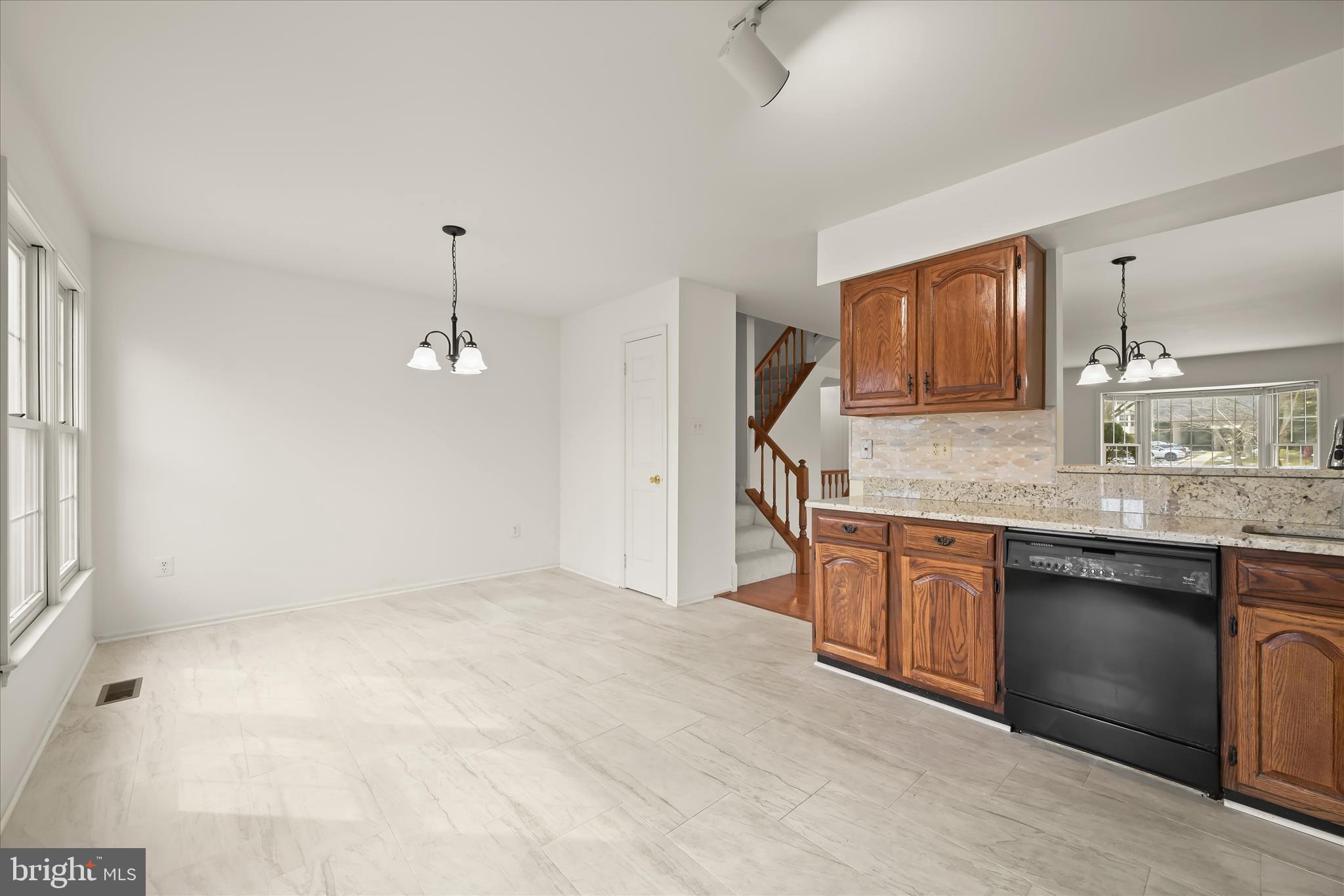 4750 Rams Horn Row Ellicott City, MD 21042 - Photo 20 of 54 a kitchen with stainless steel appliances granite countertop a sink and a granite counter tops