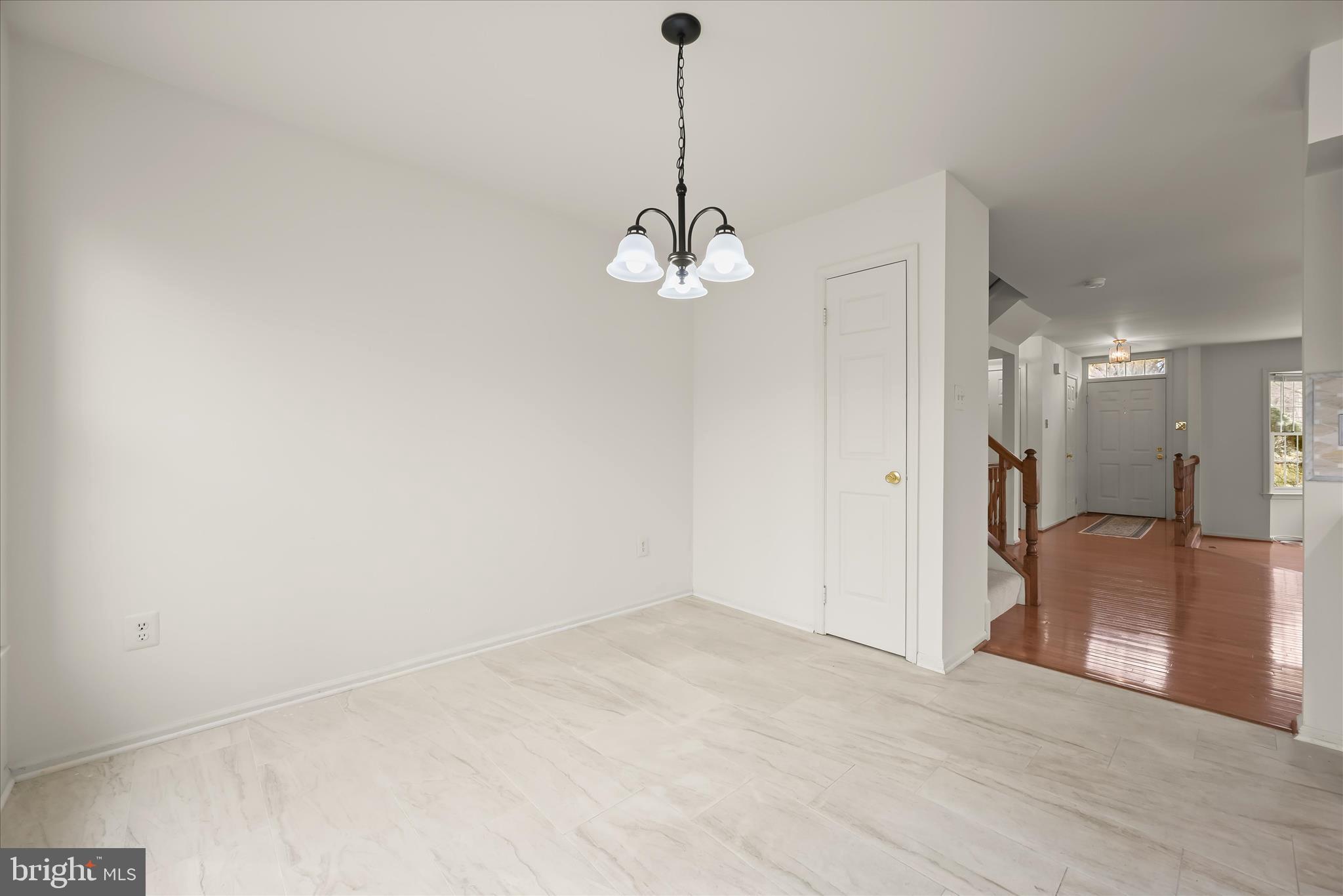 4750 Rams Horn Row Ellicott City, MD 21042 - Photo 21 of 54 a view of a hallway with wooden floor and a chandelier