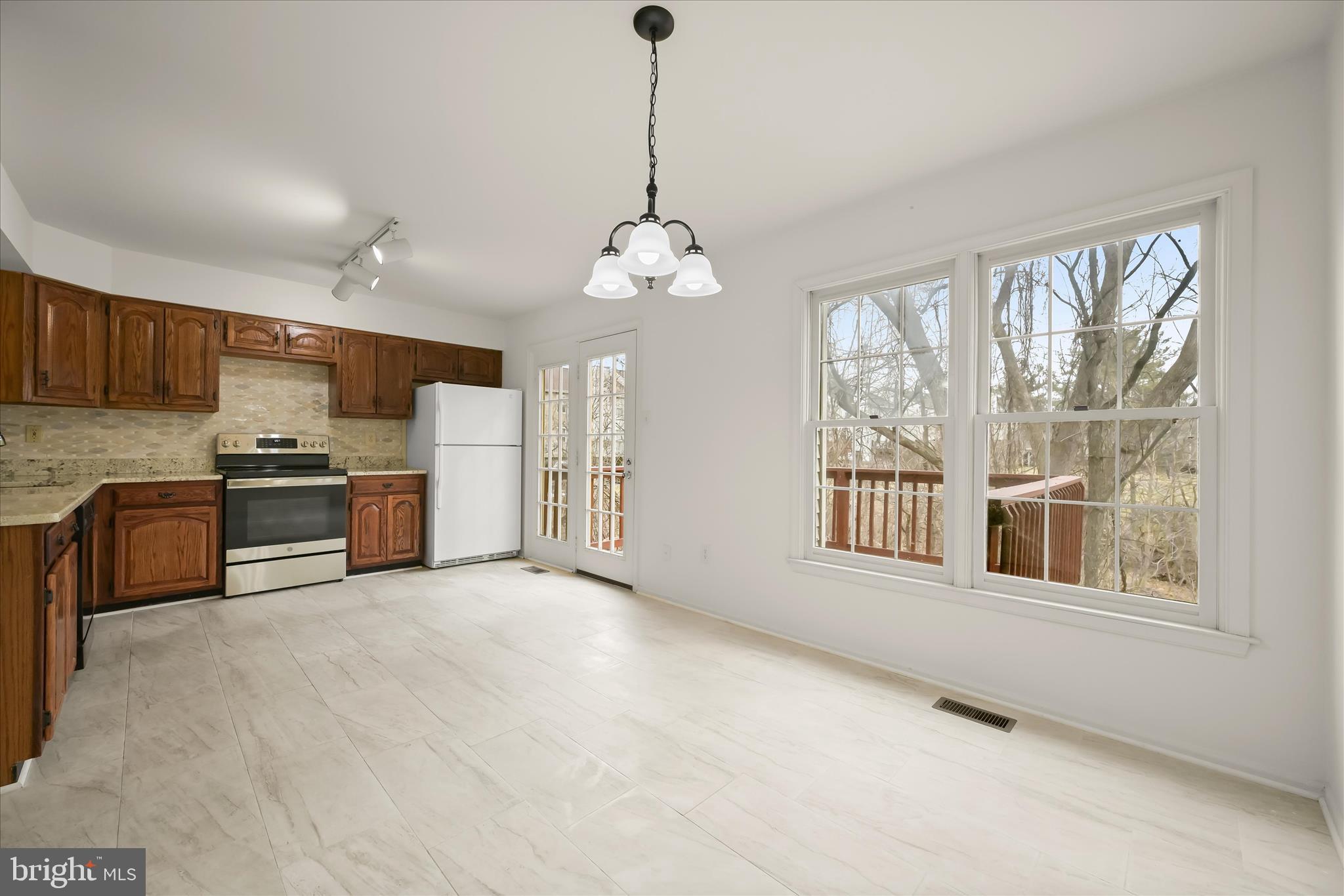 4750 Rams Horn Row Ellicott City, MD 21042 - Photo 22 of 54 a large kitchen with stainless steel appliances granite countertop a stove and a sink with cabinets