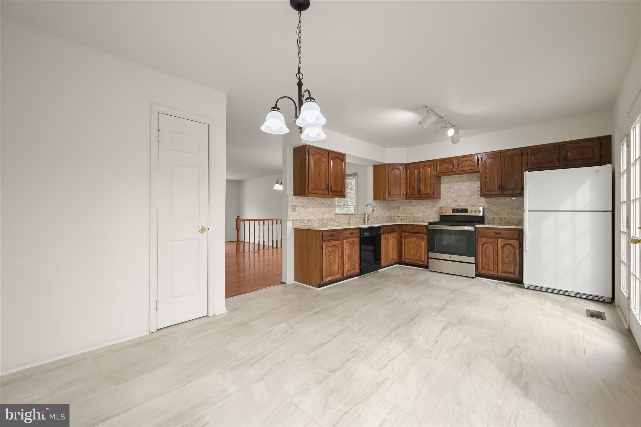 4750 Rams Horn Row Ellicott City, MD 21042 - Photo 23 of 54 a large kitchen with cabinets and stainless steel appliances