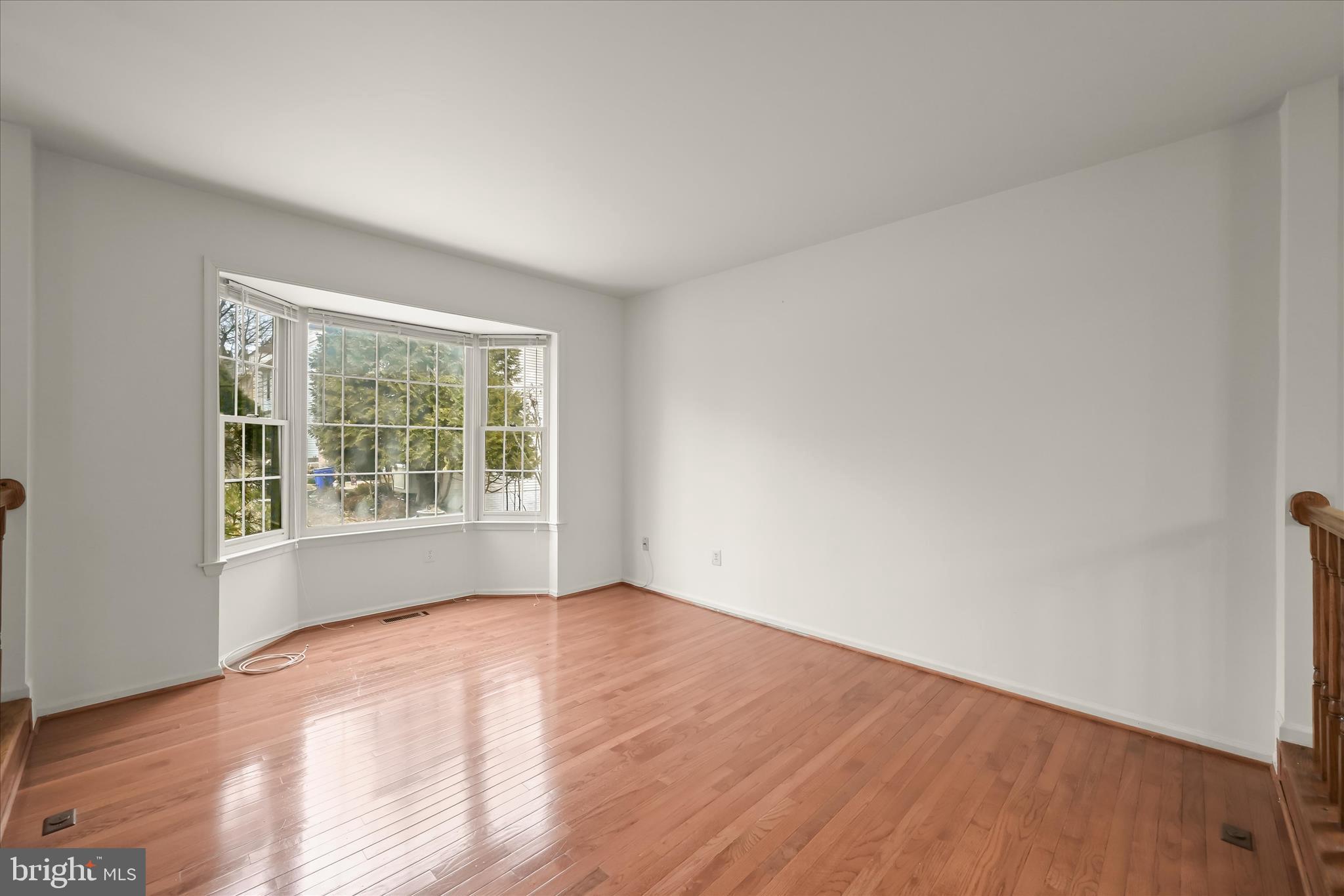 4750 Rams Horn Row Ellicott City, MD 21042 - Photo 8 of 54 a view of an empty room with wooden floor and a window
