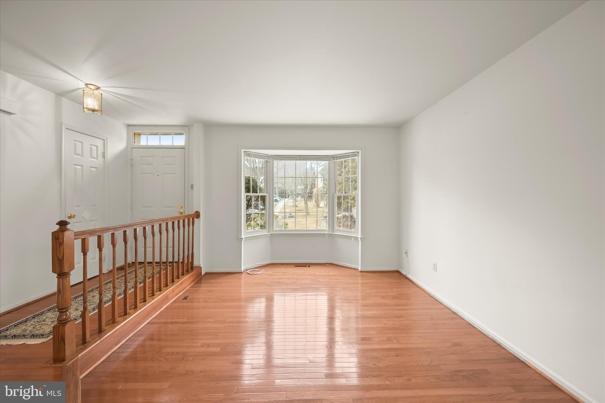 4750 Rams Horn Row Ellicott City, MD 21042 - Photo 9 of 54 a view of an empty room with wooden floor and a window