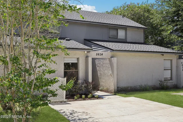 an aerial view of a house with yard