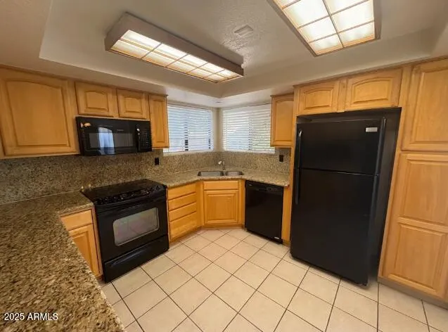 a kitchen with granite countertop a refrigerator and a stove