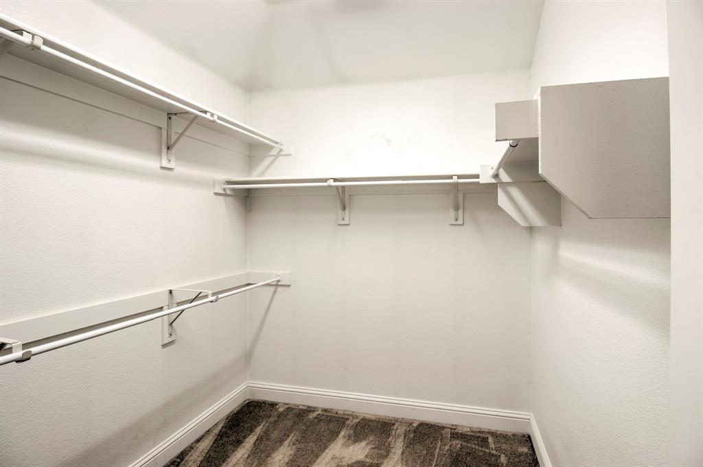 1925 Alton Way Aubrey, TX 76227 - Photo 22 of 32 a view of walk in closet with empty racks