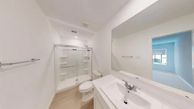 a bathroom with a toilet and a shower