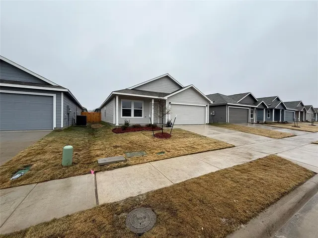 a view of a house with snow on the road