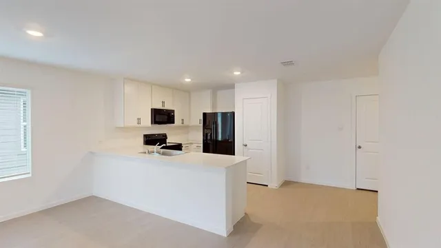 a kitchen with stainless steel appliances a refrigerator sink and microwave