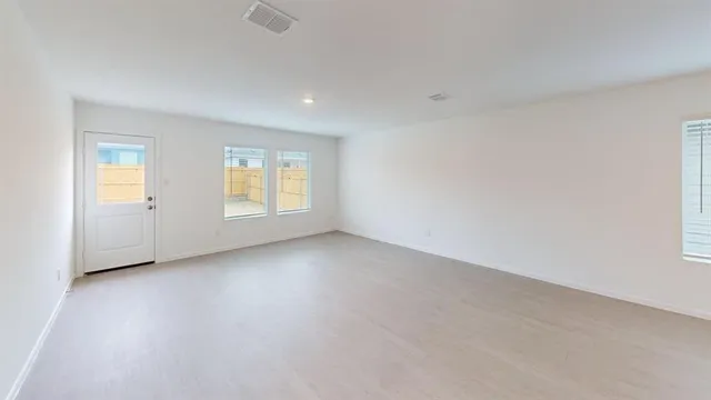 an empty room with windows and closet