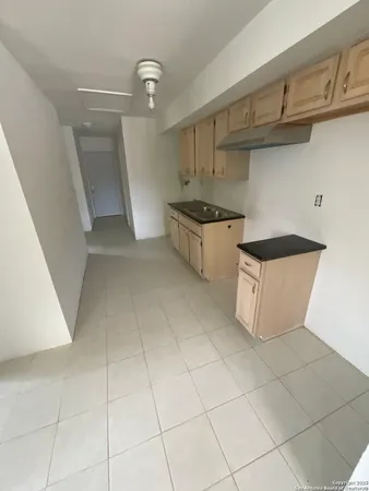 a kitchen with stainless steel appliances a sink and cabinets