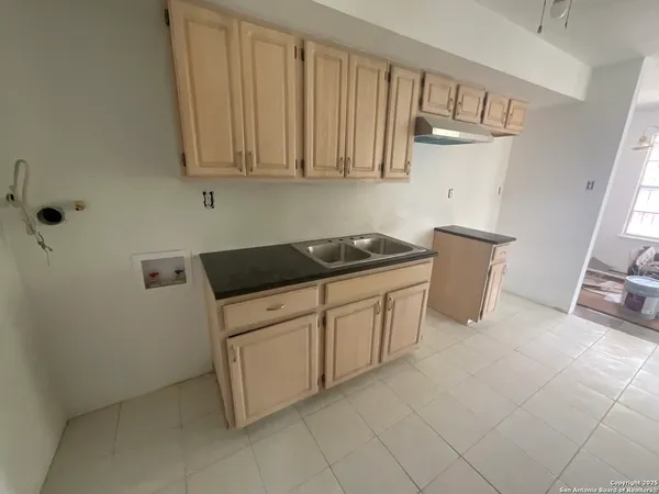 a kitchen with granite countertop white cabinets and stainless steel appliances