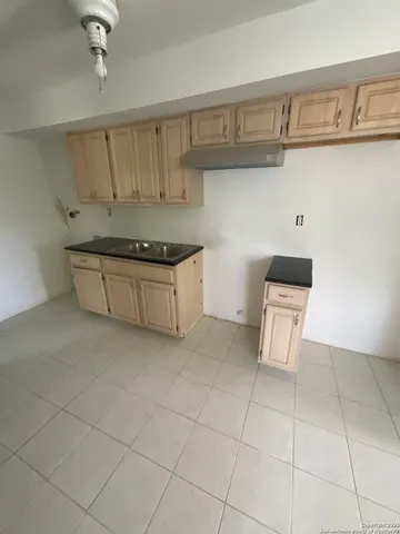a kitchen with stainless steel appliances a sink stove and cabinets
