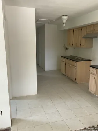 a kitchen with granite countertop a sink and cabinets