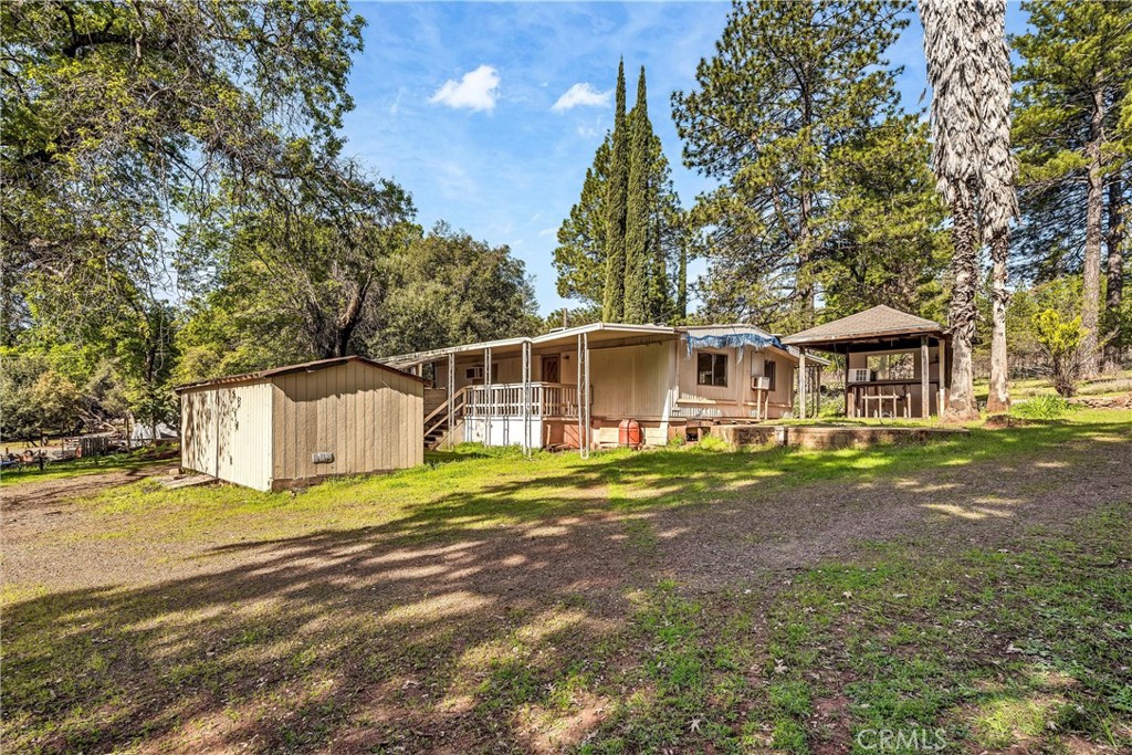 13988 Noble Ranch Road Lower Lake, CA 95457 - Photo 25 of 36 a front view of a house with a yard and trees