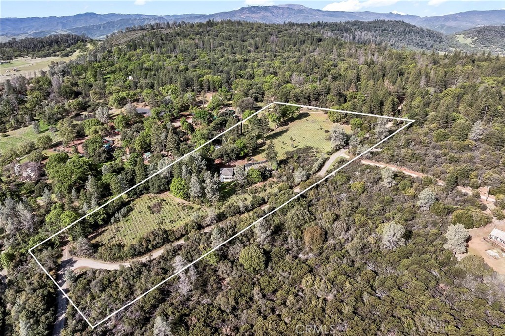 13988 Noble Ranch Road Lower Lake, CA 95457 - Photo 34 of 36 a view of a field with a mountain in the background
