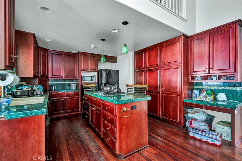 13988 Noble Ranch Road Lower Lake, CA 95457 - Photo 5 of 36 a kitchen with stainless steel appliances granite countertop a stove top oven a refrigerator and a dining table