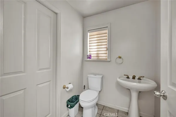 a bathroom with a sink toilet and a mirror